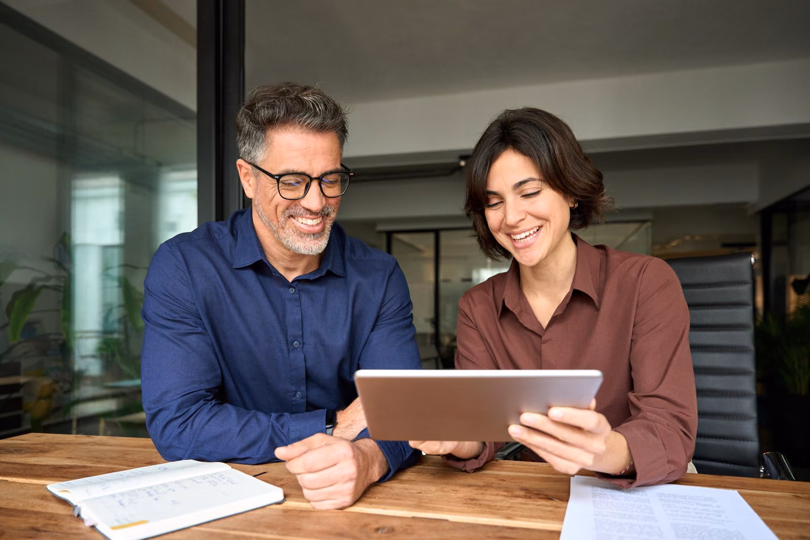 Two clients reviewing a transport plan on a tablet