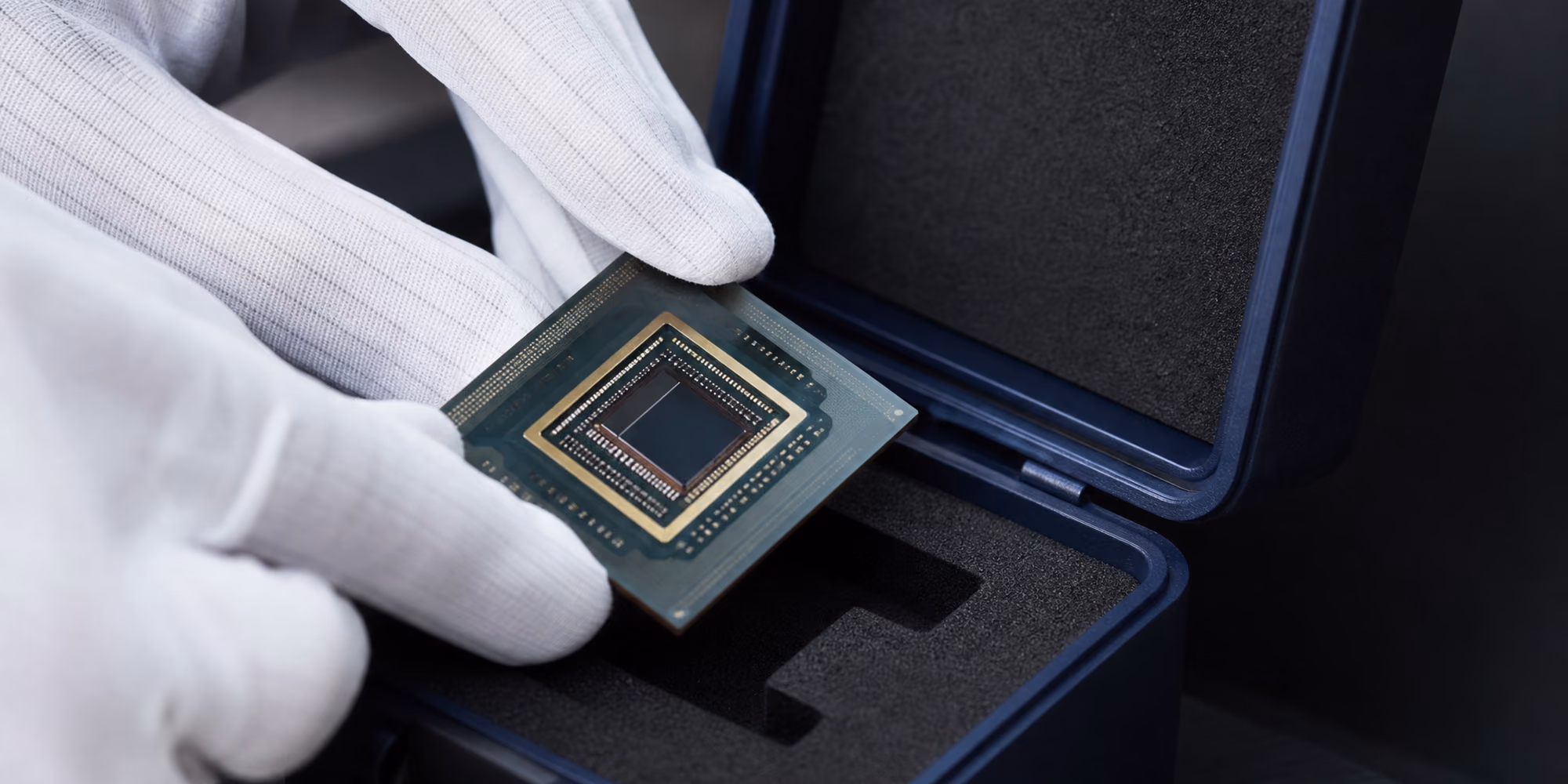 White-gloved hands placing a computer chip into a padded case