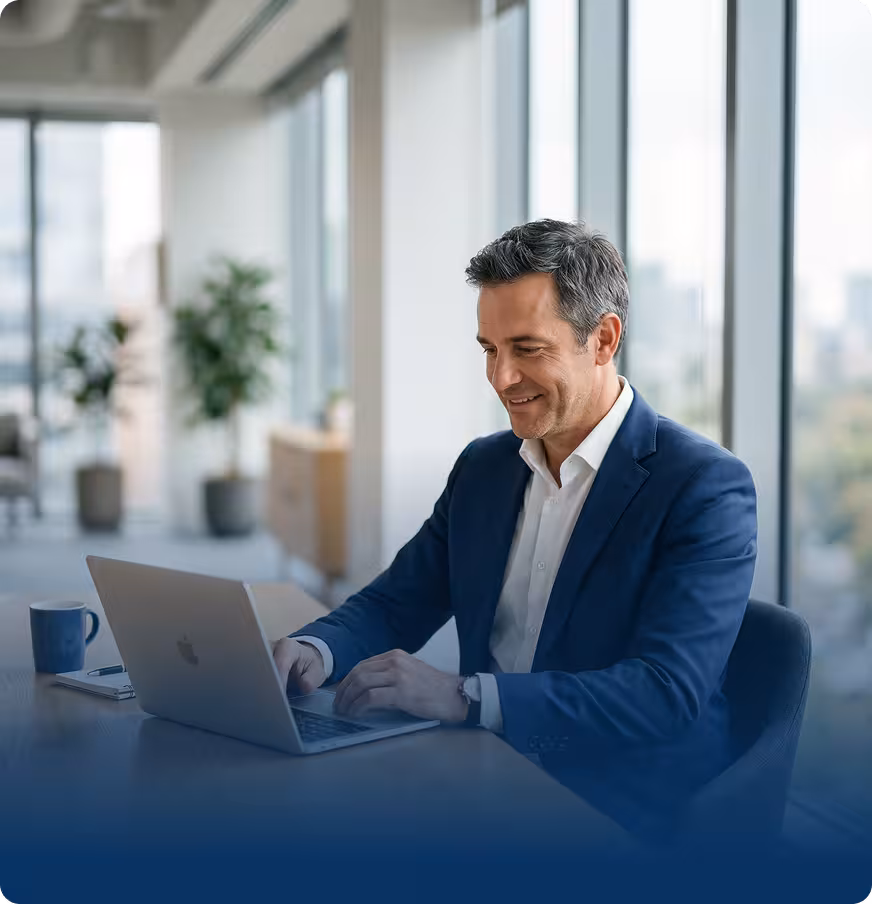 A businessman working on a laptop in a modern office