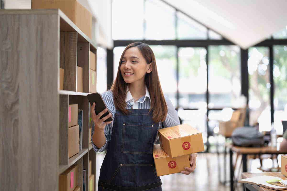 attractive asian woman hold package