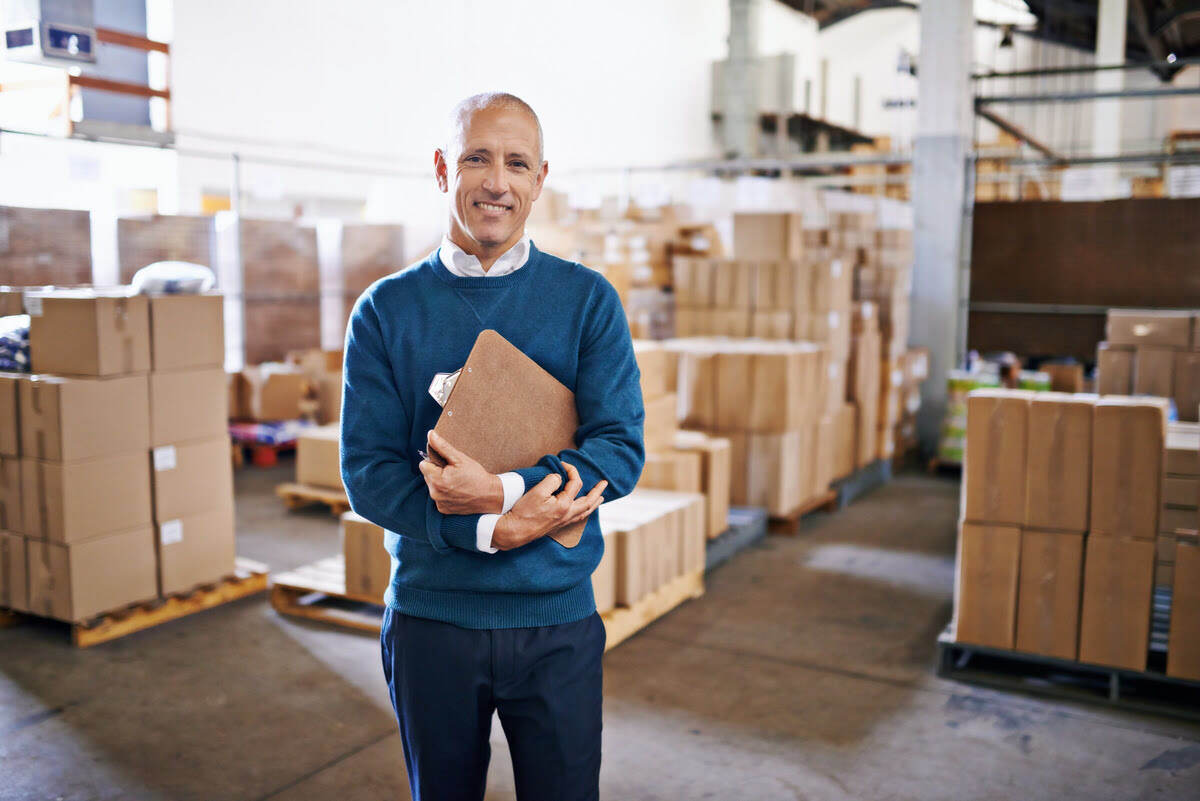 logistics manager and boxes in the background