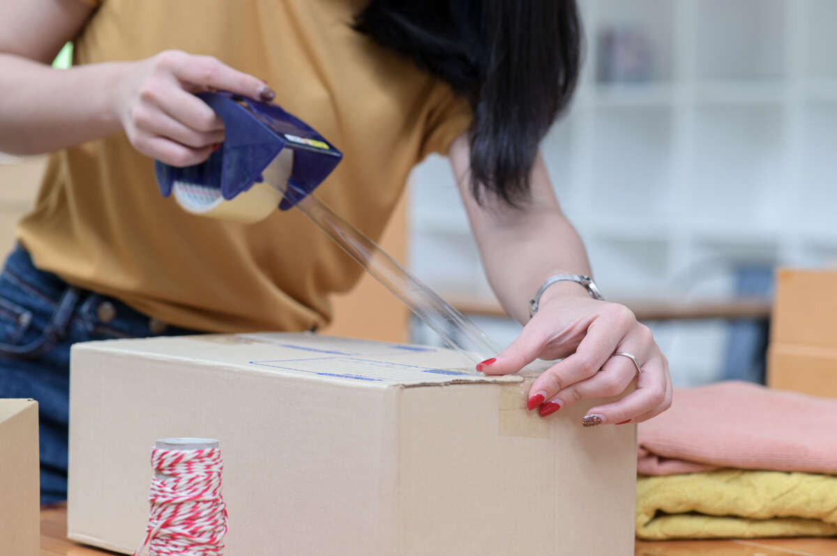 woman is preparing package for shipping