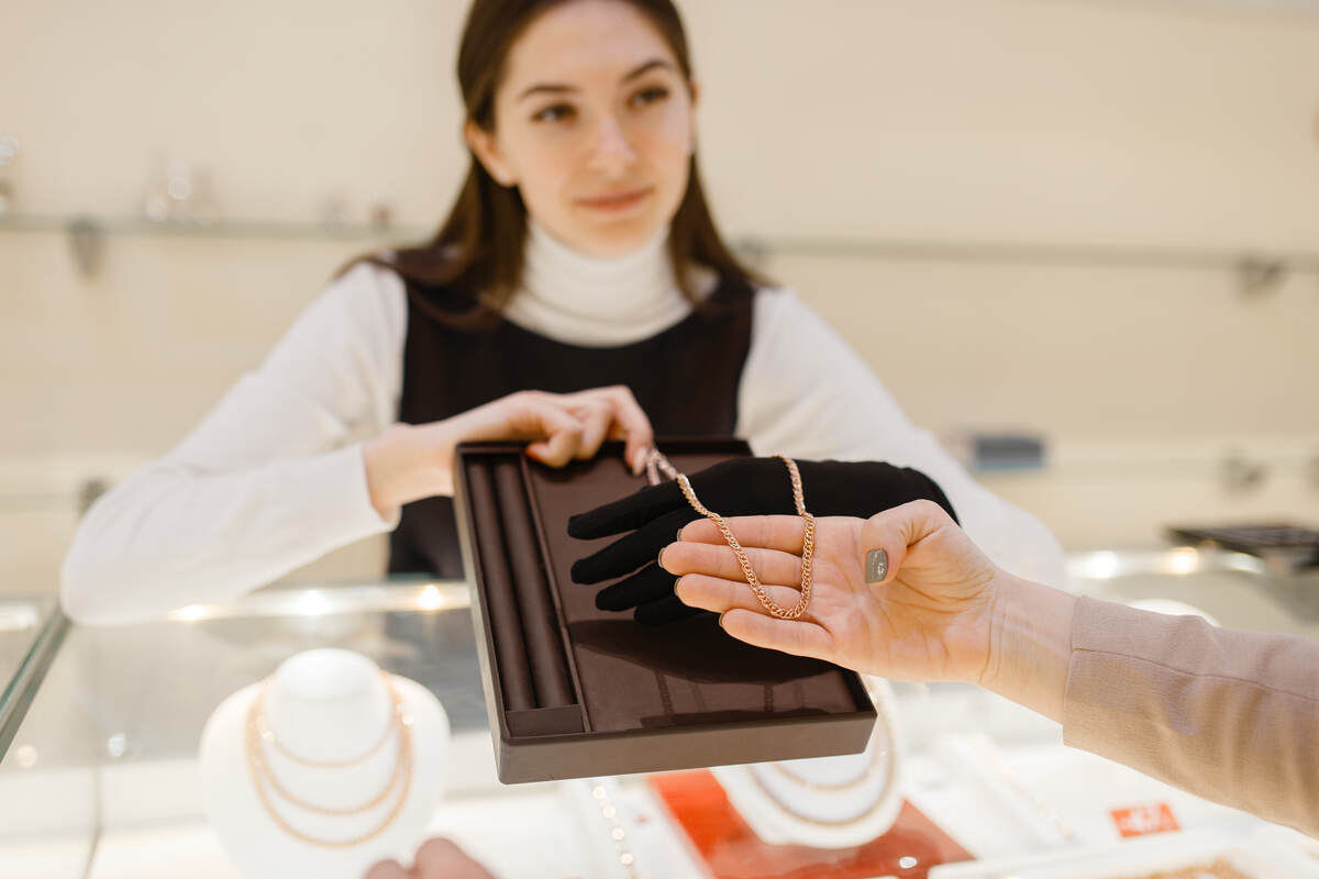 woman choosing golden chain