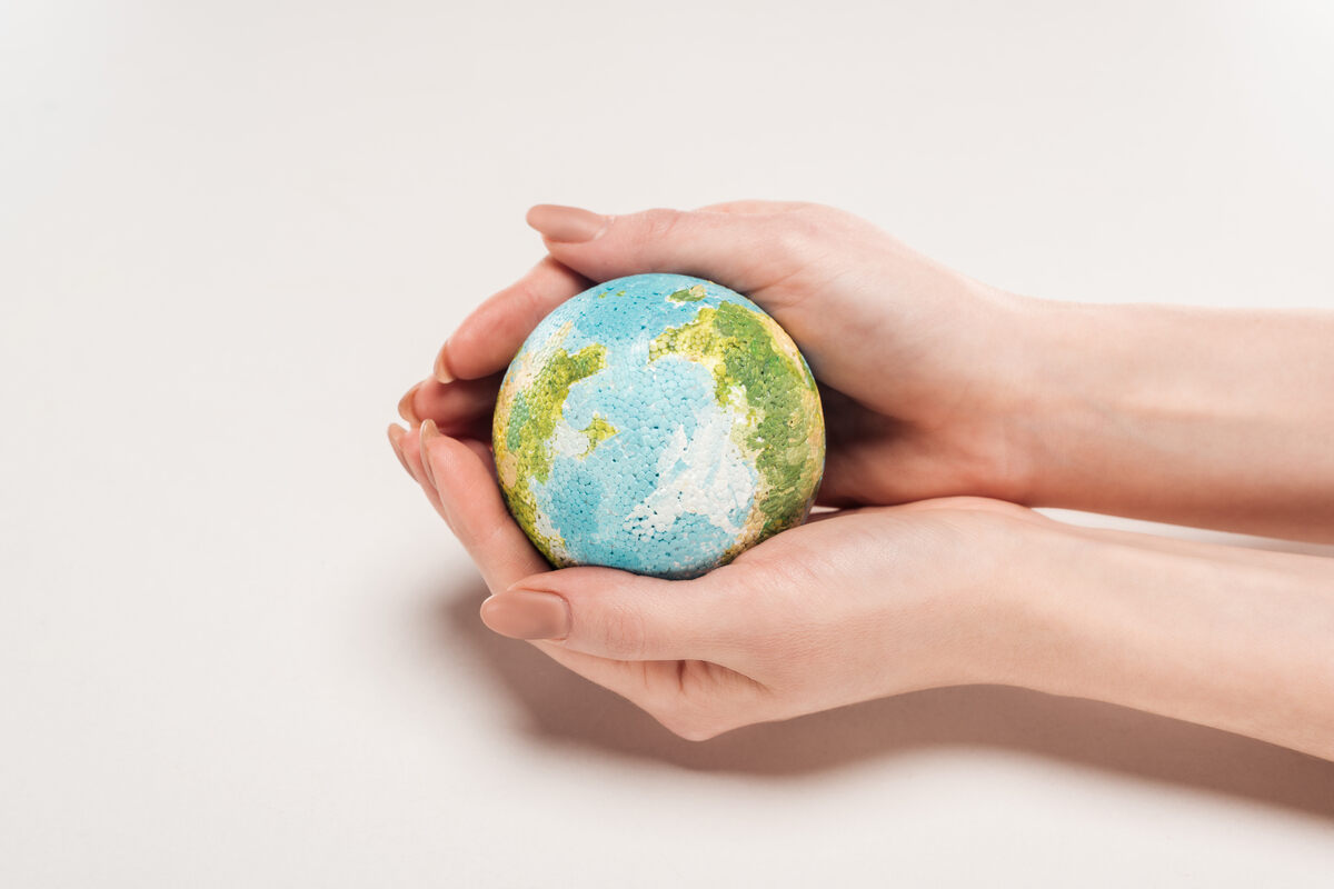Woman Holding Earth Model in her Hands
