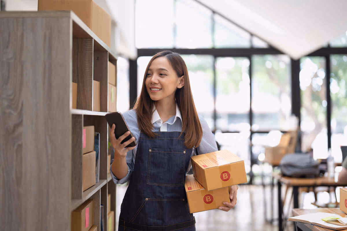 attractive asian woman hold package